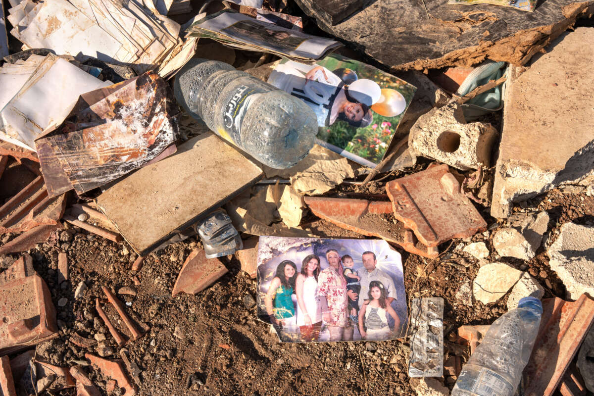 A picture of a family lies in the rubble of a building destroyed by Israeli missiles in the town of Saida, Lebanon, where 45 people were killed and 70 others wounded.