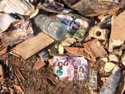 A picture of a family lies in the rubble of a building destroyed by Israeli missiles in the town of Saida, Lebanon, where 45 people were killed and 70 others wounded.