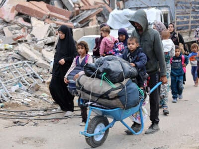 Palestinian families arrive in Gaza City after evacuating their homes in the Jabalia area after the Israeli army ordered people to evacuate the area north of Gaza, on October 6, 2024.