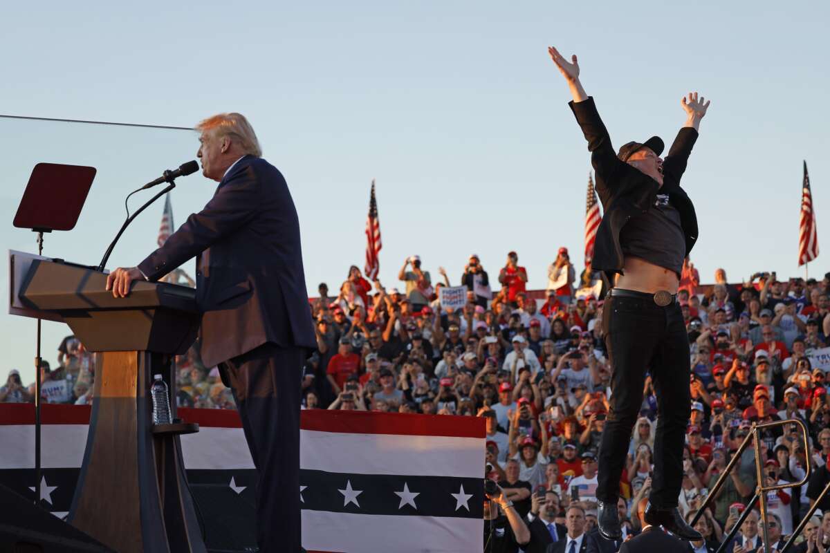 Elon Musk leaps on stage with Republican presidential nominee Donald Trump during a campaign rally on October 5, 2024, in Butler, Pennsylvania.