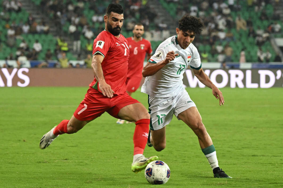 Iraq's forward #17 Ali Jasim and Palestine's defender #07 Musab Batat vie for the ball during the 2026 FIFA World Cup Asian qualification football match between Iraq and Palestine at Basra International Stadium in Basra, Iraq, on October 10, 2024.