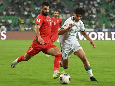 Iraq's forward #17 Ali Jasim and Palestine's defender #07 Musab Batat vie for the ball during the 2026 FIFA World Cup Asian qualification football match between Iraq and Palestine at Basra International Stadium in Basra, Iraq, on October 10, 2024.