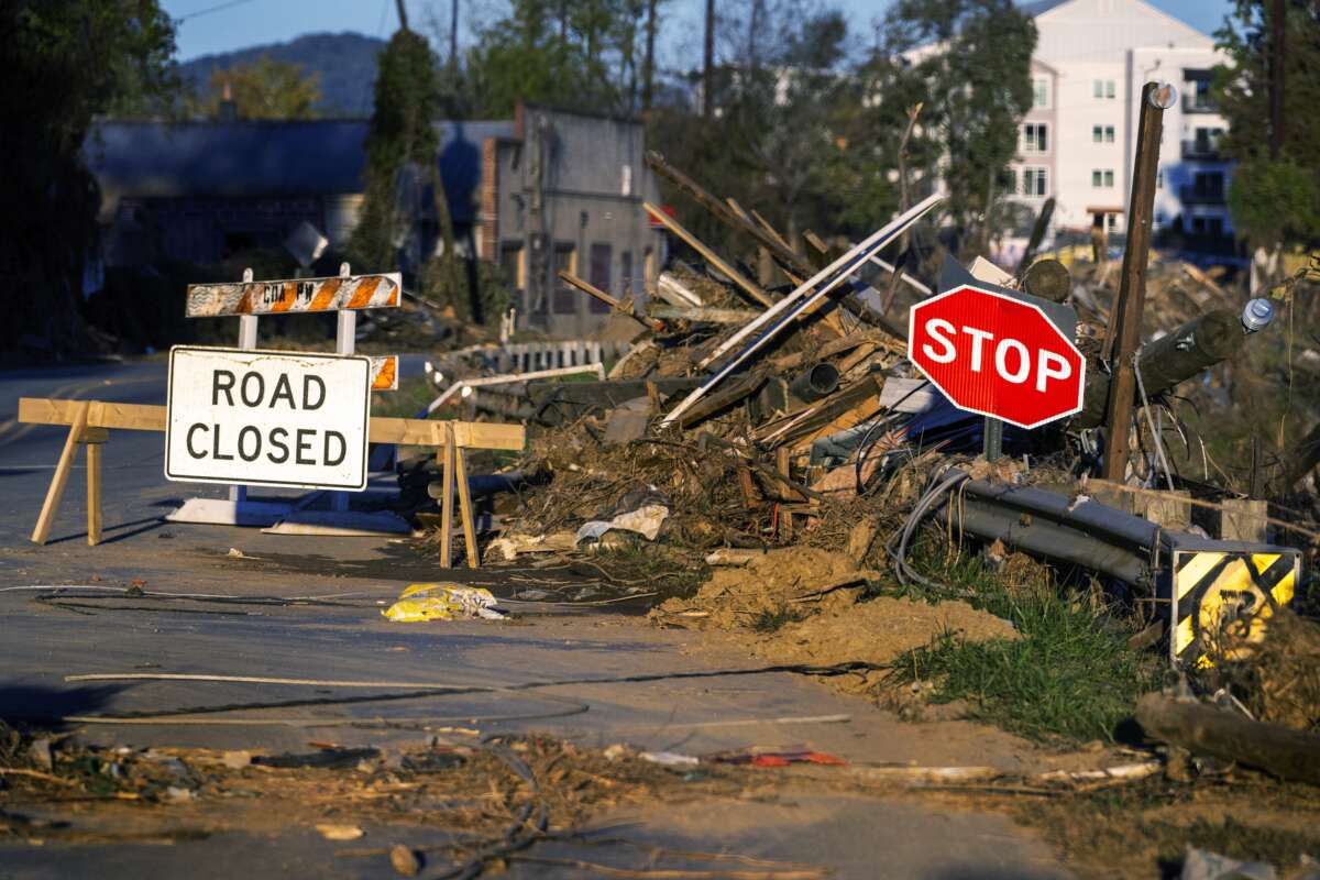 Debris covers a closed street near the Swannanoa River in Asheville, North Carolina, on October 20, 2024, as clean-up efforts continue after Hurricane Helene devastated the area.