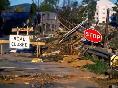 Debris covers a closed street near the Swannanoa River in Asheville, North Carolina, on October 20, 2024, as clean-up efforts continue after Hurricane Helene devastated the area.