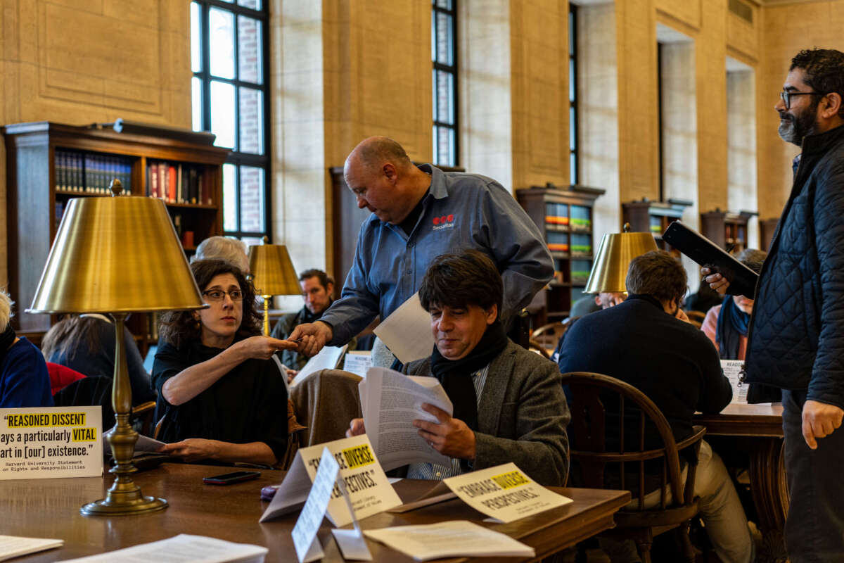 Security guards demand Harvard professors' ID cards during a silent study session in the library on October 16, 2024.