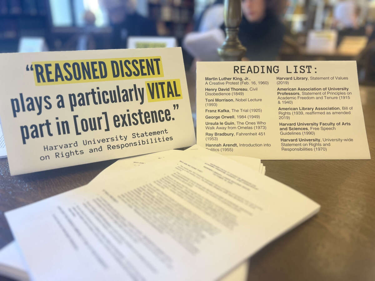 A sign is displayed by Harvard professors during a silent study session in the university’s main library on October 16, 2024.