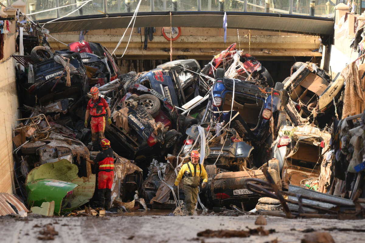 Members of the fire brigade, which are part of a search and rescue unit, carry out work as cars and debris block a tunnel in the border of Benetusser and Alfafar municipalities after the recent flash flooding on November 1, 2024, in the Benetusser municipality of Valencia, Spain.