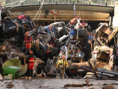 Members of the fire brigade, which are part of a search and rescue unit, carry out work as cars and debris block a tunnel in the border of Benetusser and Alfafar municipalities after the recent flash flooding on November 1, 2024, in the Benetusser municipality of Valencia, Spain.