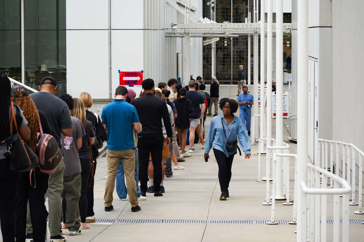 Voters head into a polling location to cast their ballots on the last day of early voting for the 2024 election on November 1, 2024, in Atlanta, Georgia.