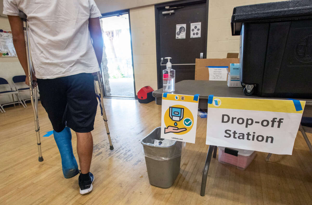 A person in crutches exits a polling place