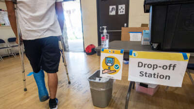 A person in crutches exits a polling place