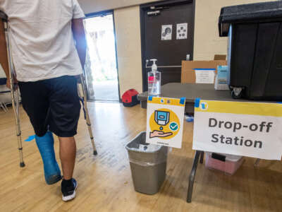 A person in crutches exits a polling place