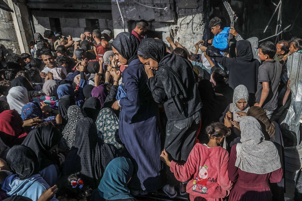 Displaced Palestinians line up for bread at the only bakery left in the city of Khan Younis on October 24, 2024.