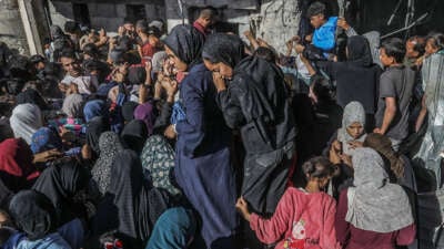 Displaced Palestinians line up for bread at the only bakery left in the city of Khan Younis on October 24, 2024.