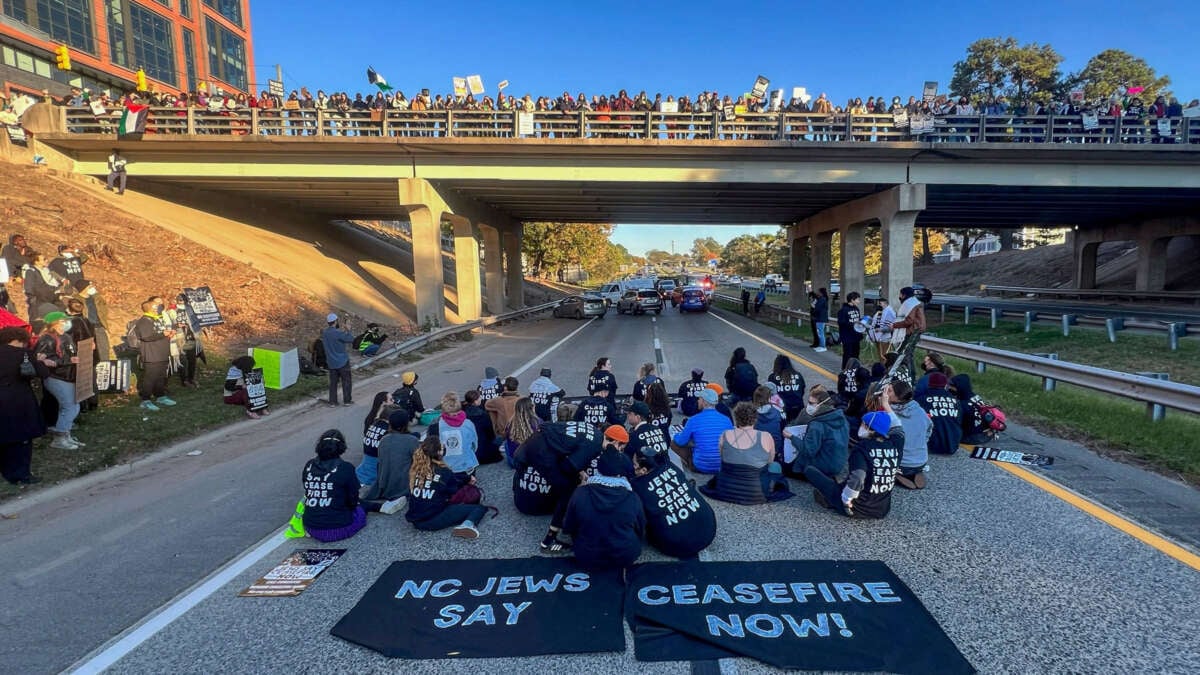 Demonstrators with Jewish Voice for Peace block the northbound lanes of the Durham Freeway at the South Magnum Street bridge for hours to demand a ceasefire in the war on Gaza, on November 2, 2023, in Durham, North Carolina.