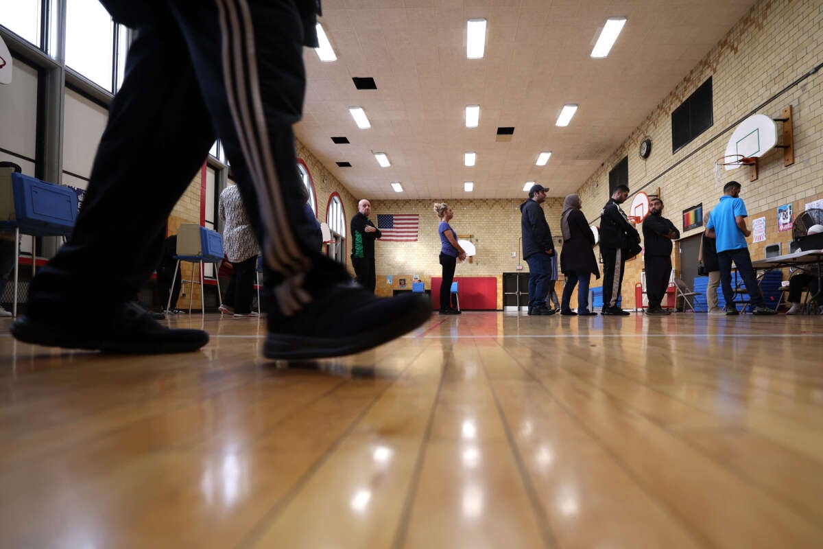 Voters wait in line to vote at the Lowrey School on November 5, 2024, in Dearborn, Michigan.