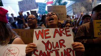 People protest then-President Donald Trump's travel ban at the Tom Bradley International Terminal at LAX on January 29, 2017, in Los Angeles, California.