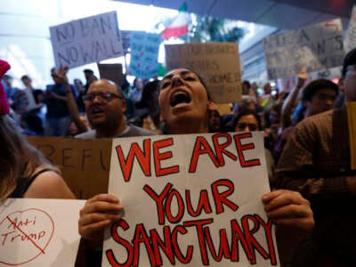 People protest then-President Donald Trump's travel ban at the Tom Bradley International Terminal at LAX on January 29, 2017, in Los Angeles, California.