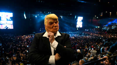A supporter of Argentinian President Javier Milei wears a mask of former U.S. President Donald Trump during a promotional event for a new book by the Argentinian head of state.