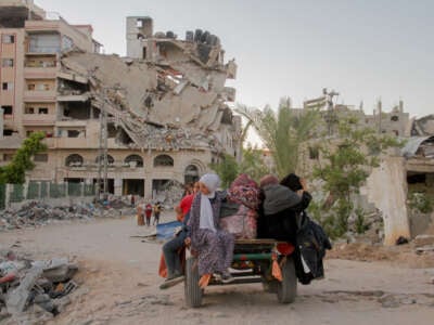 Displaced Palestinians, ordered by the Israeli army to leave the school in Beit Lahia where they were sheltered, arrive in Gaza City on October 19, 2024.