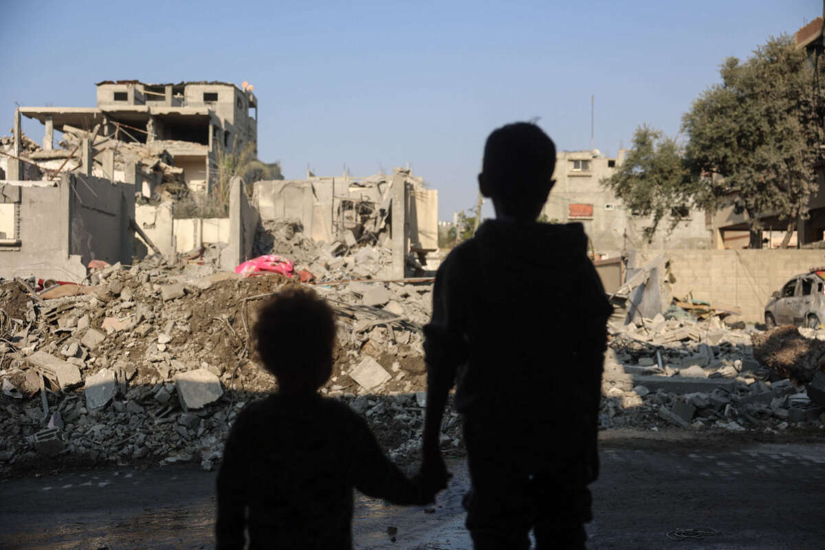 Children stare at the destruction following an Israeli strike in the Nuseirat refugee camp in the central Gaza Strip on November 7, 2024.