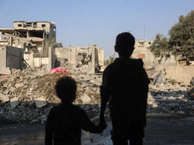 Children stare at the destruction following an Israeli strike in the Nuseirat refugee camp in the central Gaza Strip on November 7, 2024.