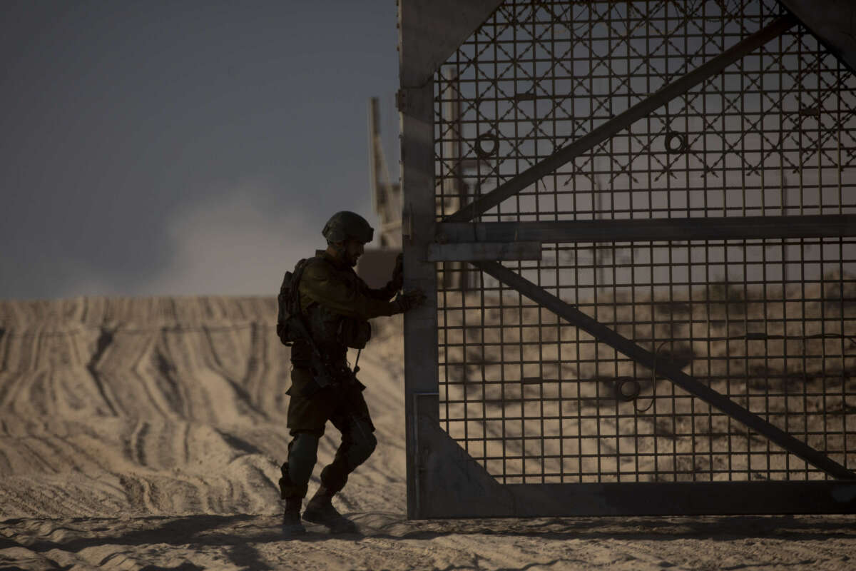 An Israeli soldier closes the border fence leading to the Gaza Strip on November 11, 2024, in Erez West Crossing, Israel.