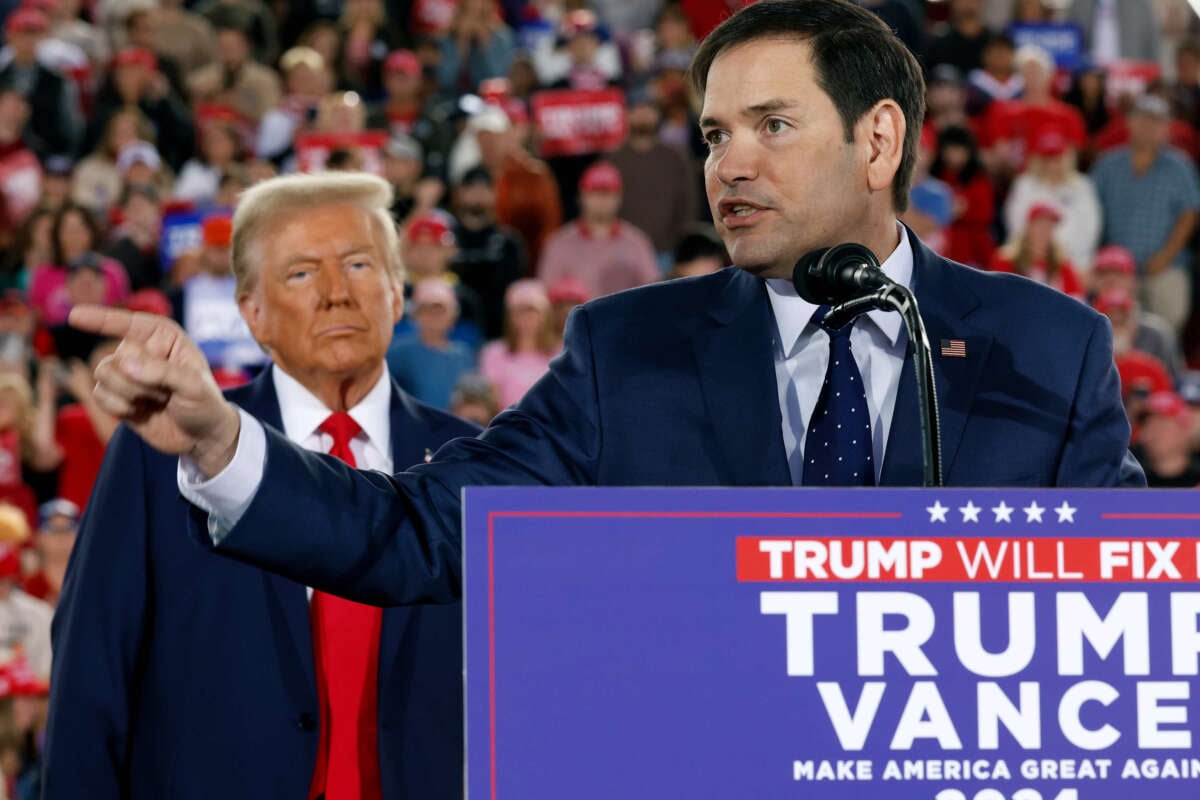 President-elect and former President Donald Trump watches as Sen. Marco Rubio speaks during Trump's campaign rally at the J.S. Dorton Arena on November 4, 2024, in Raleigh, North Carolina.