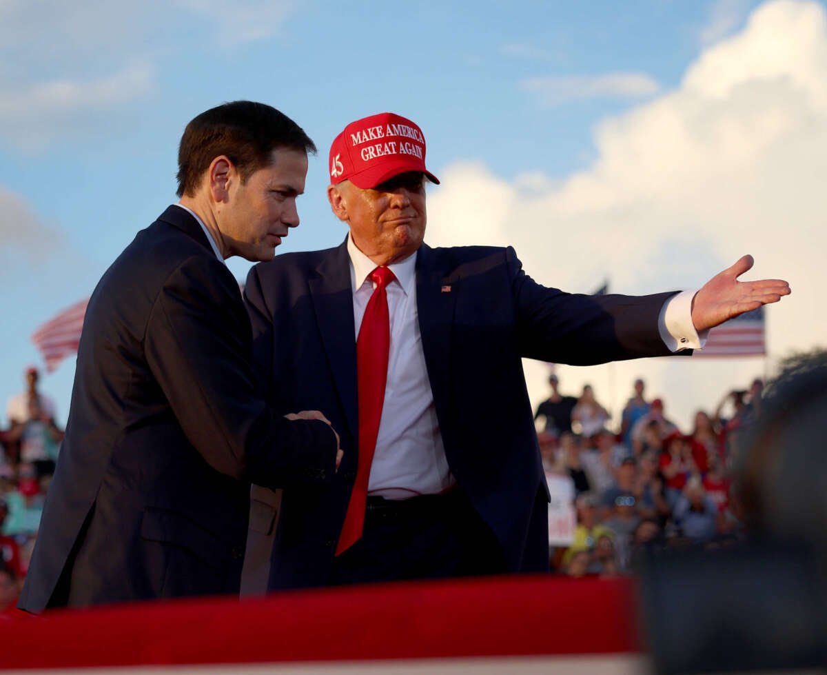 Former President Donald Trump invites Sen. Marco Rubio to speak at the microphone during a rally at the Miami-Dade County Fair and Exposition on November 6, 2022, in Miami, Florida.