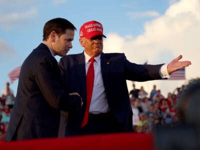 Former President Donald Trump invites Sen. Marco Rubio to speak at the microphone during a rally at the Miami-Dade County Fair and Exposition on November 6, 2022, in Miami, Florida.