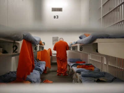 Incarcerated people are seen through bars on the front of a cell on the main line at the jail at the Hall of Justice on December 1, 2015, in San Francisco, California.