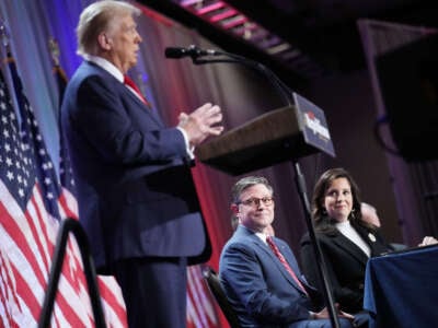 Speaker of the House Mike Johnson (center) and House Republican Conference Chair Rep. Elise Stefanik (right) listen as President-elect Donald Trump speaks at a House Republicans Conference meeting at the Hyatt Regency on Capitol Hill on November 13, 2024, in Washington, D.C.