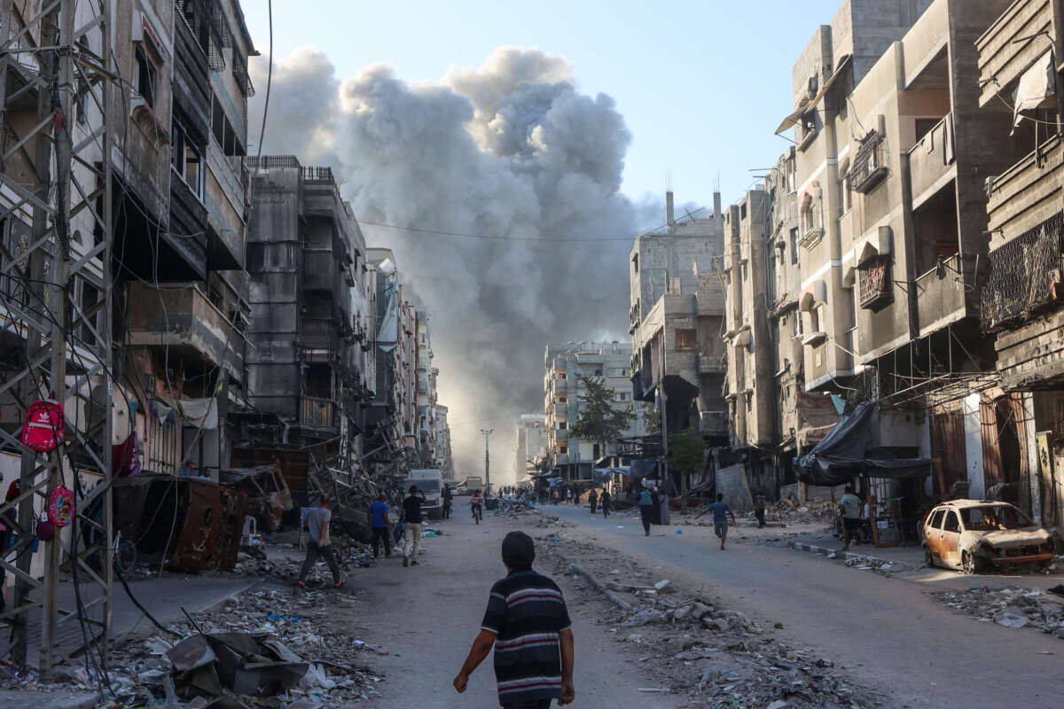 Palestinians rush towards a column of smoke billowing following Israeli bombardment which hit a school complex, including the Hamama and al-Huda schools, in the Sheikh Radwan neighbourhood in the north of Gaza City on August 3, 2024.