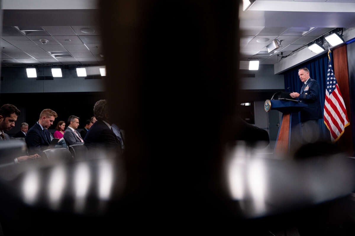 Pentagon Press Secretary Maj. Gen. Pat Ryder speaks to reporters while visually separated by the silhouette of a person's head