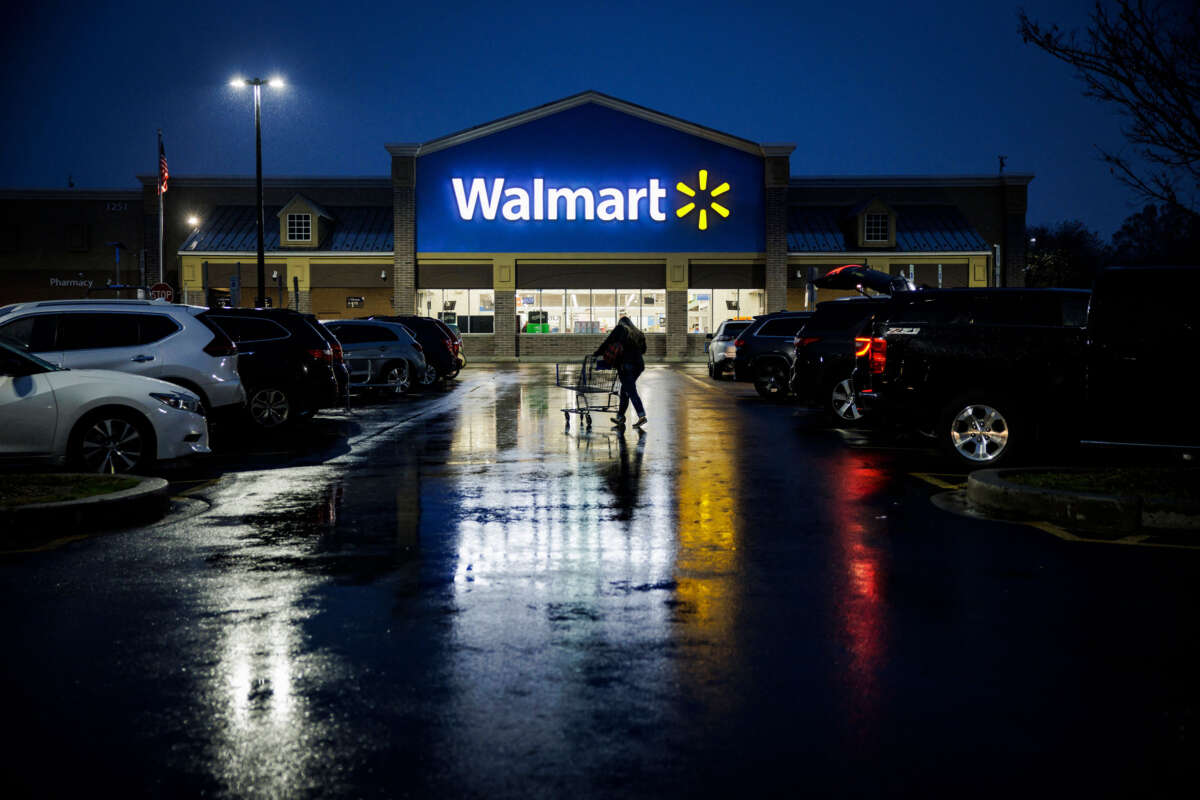 A shopper pushes a cart through the parking lot of a Walmart in Wilmington, Delaware, on November 25, 2022.