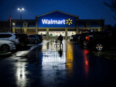 A shopper pushes a cart through the parking lot of a Walmart in Wilmington, Delaware, on November 25, 2022.