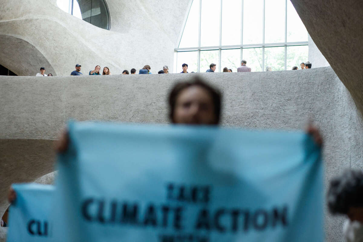 Climate activists with the group Extinction Rebellion protest inside the Museum of Natural History in New York City, on August 18, 2024.