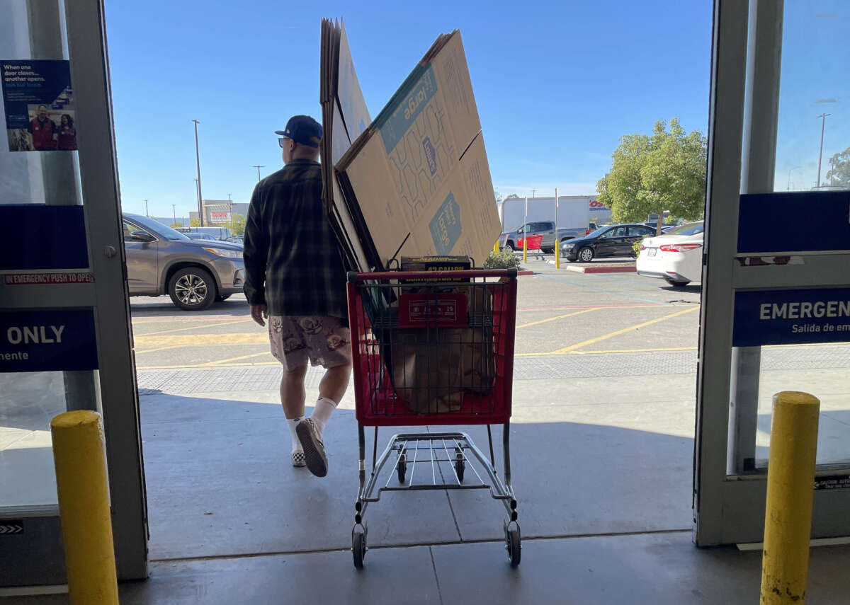 A customer pulls a shopping cart as he leaves a Lowe's store on November 21, 2023, in Pacoima, California.