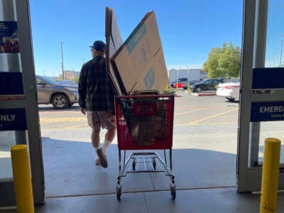 A customer pulls a shopping cart as he leaves a Lowe's store on November 21, 2023, in Pacoima, California.