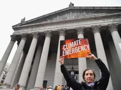 Climate activists gather on the first day of the ExxonMobil trial outside the New York State Supreme Court building on October 22, 2019, in New York City.