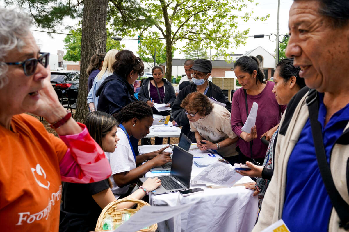 In an event hosted by Second Story, families gather for resources including Medicaid eligibility and enrollment information offered by Neighborhood Health, outside the Springfield/Franconia Family Resources Center on April 27, 2023, in Springfield, Virginia.