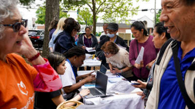 In an event hosted by Second Story, families gather for resources including Medicaid eligibility and enrollment information offered by Neighborhood Health, outside the Springfield/Franconia Family Resources Center on April 27, 2023, in Springfield, Virginia.