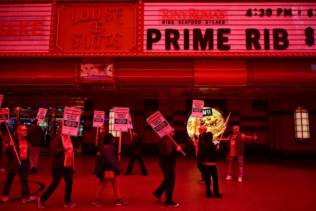 Supporters of the Culinary Workers and Bartenders Unions carry picket signs calling for a fair contract ahead of a strike deadline outside of the Fremont Hotel & Casino in downtown Las Vegas, Nevada, on February 2, 2024.