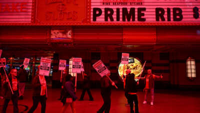 Supporters of the Culinary Workers and Bartenders Unions carry picket signs calling for a fair contract ahead of a strike deadline outside of the Fremont Hotel & Casino in downtown Las Vegas, Nevada, on February 2, 2024.