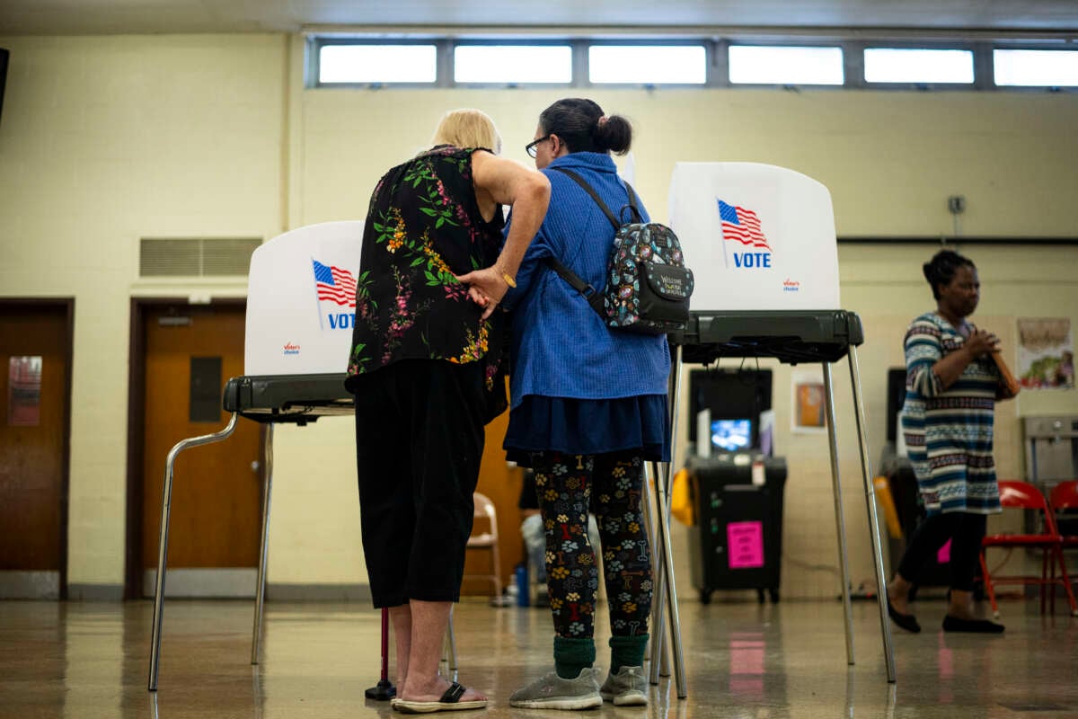 Voting booths and voters are seen at a polling location at Beltsville Academy on Election Day, November 5, 2024, in Beltsville, Maryland.