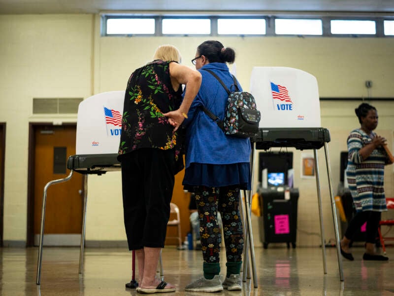 Voting booths and voters are seen at a polling location at Beltsville Academy on Election Day, November 5, 2024, in Beltsville, Maryland.