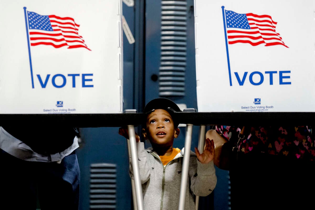 Khalil Wallace, 3, of Detroit waits while his father, Al Wallace, 41, votes at Detroit Fire Department - Station 44 in Detroit, Michigan, on November 5, 2024.