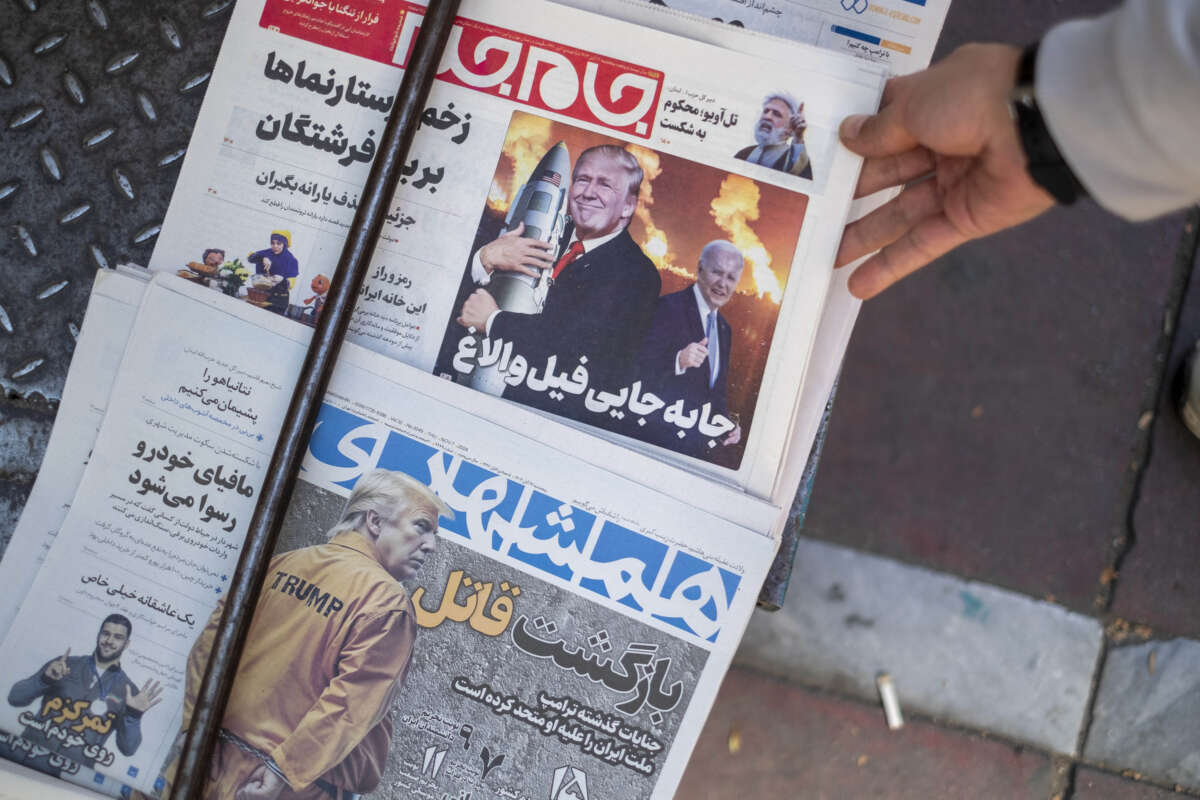 An Iranian man picks up a newspaper with an image of the U.S. President-elect, Donald Trump, published on its front page in downtown Tehran, Iran, on November 7, 2024.