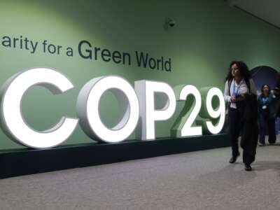 Participants walk past the hashtag COP29 logo on the opening day of the COP29 Climate Conference on November 11, 2024 in Baku, Azerbaijan.