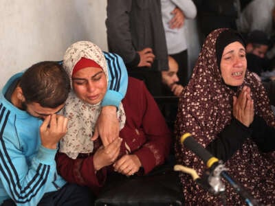 Palestinians mourn relatives killed in an Israeli airstrike, at Al-Ahli Arab hospital, also known as the Baptist hospital, in Gaza City, on November 26, 2024.